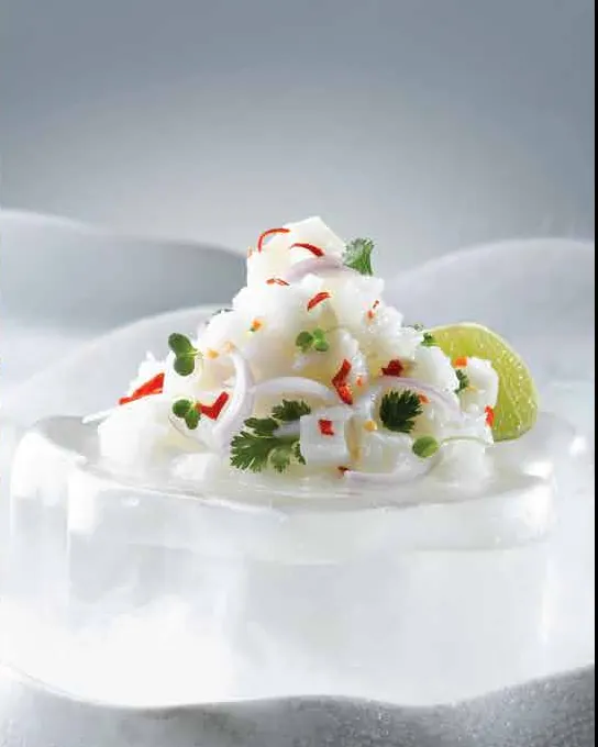 Sea bass ceviche with chilli, shallot and lime, served on a block of ice in a misty white setting