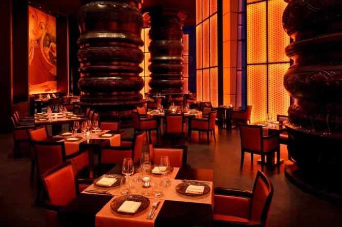 Masala Library dining room with red leather chairs, set tables and backlit amber panels